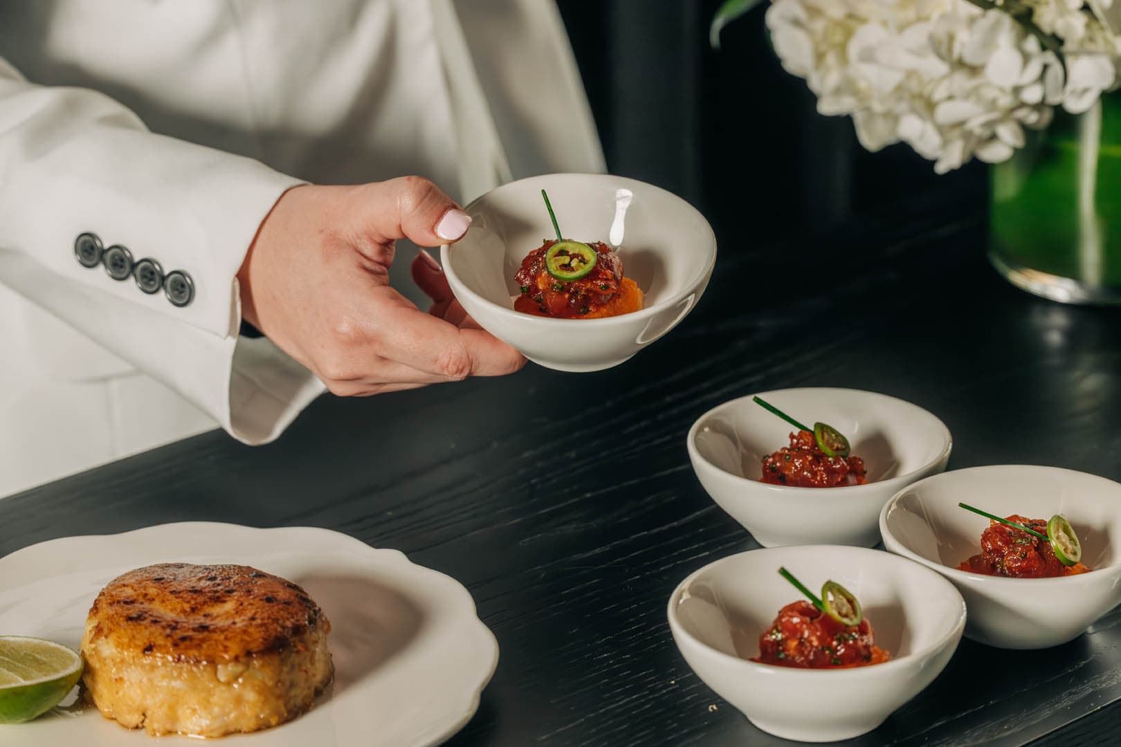 A server hands out crispy rice topped with tuna at the Meta Apex Center, a premier event venue in Las Vegas